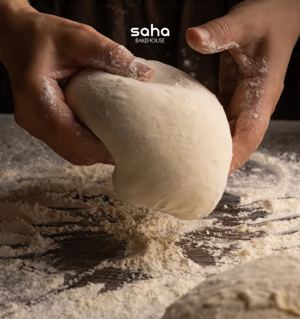 Baker shaping dough by hand